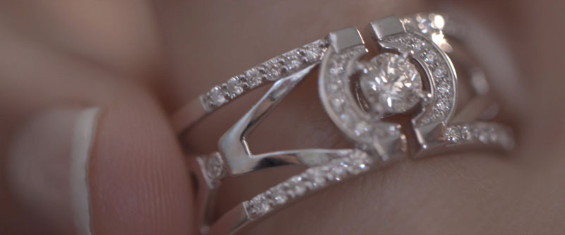 Une magnifique bague en diamants est ajustée sur le doigt d'une femme